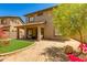 Backyard featuring covered patio, artificial grass, mature tree and low maintenance landscaping at 6626 W Laurel Ave, Glendale, AZ 85304