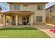 Backyard with covered patio and seating area, complemented by desert landscaping and a small turf area at 6626 W Laurel Ave, Glendale, AZ 85304