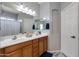 Bathroom with double sink vanity, white cabinets and framed mirrors and updated hardware at 6626 W Laurel Ave, Glendale, AZ 85304