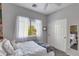 Cozy bedroom featuring gray carpet, a window, and a closet with sliding doors at 6626 W Laurel Ave, Glendale, AZ 85304