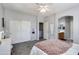 Spacious bedroom with closet, ensuite bathroom, lighted vanity, and gray colored carpet at 6626 W Laurel Ave, Glendale, AZ 85304