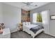 Bedroom with a colorful accent wall, a window overlooking a landscaped yard and gray carpet at 6626 W Laurel Ave, Glendale, AZ 85304