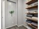 Neutral toned closet showcasing shelving and decorative niche with inset for plants or other decorations at 6626 W Laurel Ave, Glendale, AZ 85304