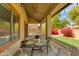 A cozy covered patio with a table and chairs, perfect for relaxing and entertaining outdoors at 6626 W Laurel Ave, Glendale, AZ 85304