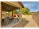 Outdoor living space on the covered patio with dining and lounge area, overlooking the desert landscaped yard at 6626 W Laurel Ave, Glendale, AZ 85304