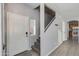Welcoming entryway featuring a white door, carpeted stairs, and tiled flooring at 6626 W Laurel Ave, Glendale, AZ 85304