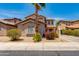Charming two-story home exterior with desert landscaping and a well manicured yard at 6626 W Laurel Ave, Glendale, AZ 85304