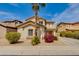 Charming two-story home featuring a desert landscape, mature palm tree, and neutral stucco exterior at 6626 W Laurel Ave, Glendale, AZ 85304