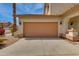 A two car garage with brown colored doors and desert landscaping at 6626 W Laurel Ave, Glendale, AZ 85304