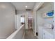 Upstairs hallway leading to bedrooms and bathroom with a laundry area including a washer and dryer at 6626 W Laurel Ave, Glendale, AZ 85304