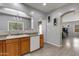 Open concept kitchen with light oak cabinets, white appliances and breakfast bar at 6626 W Laurel Ave, Glendale, AZ 85304