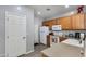 Well-lit kitchen features oak cabinets, white appliances, and ample counter space at 6626 W Laurel Ave, Glendale, AZ 85304