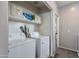 Laundry room features a full-size washer and dryer, with storage shelves for laundry supplies at 6626 W Laurel Ave, Glendale, AZ 85304