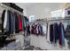 Organized walk-in closet with rows of hanging clothes, shelves for shoes, and built-in storage at 6626 W Laurel Ave, Glendale, AZ 85304