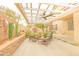 Relaxing backyard patio with water feature, pergola, ceiling fan and wicker furniture at 6778 W Lariat Ln, Peoria, AZ 85383
