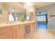 Bright primary bathroom with tile floor, double sinks, and a large mirror at 6778 W Lariat Ln, Peoria, AZ 85383