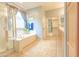 Primary bathroom with a shower, bath, and double sinks at 6778 W Lariat Ln, Peoria, AZ 85383