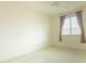 Bright bedroom with neutral carpet, window with blinds and curtains at 6778 W Lariat Ln, Peoria, AZ 85383