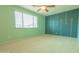 An empty bedroom with carpeted floors, a window with natural light, and unique painted accent wall at 6778 W Lariat Ln, Peoria, AZ 85383