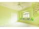 Bright bedroom featuring a window seat, shutters, a ceiling fan, and an artistic tree mural at 6778 W Lariat Ln, Peoria, AZ 85383