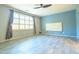 Spacious primary bedroom with blue walls, window, and wood-look tile flooring at 6778 W Lariat Ln, Peoria, AZ 85383