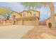 Two-story home with tan stucco exterior, three-car garage, and desert landscaping at 6778 W Lariat Ln, Peoria, AZ 85383