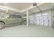 Spacious garage with an olive green pickup truck, paneled garage door and a well lit interior at 6778 W Lariat Ln, Peoria, AZ 85383