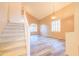 Bright living room features a staircase, high ceilings and stylish wood-look flooring at 6778 W Lariat Ln, Peoria, AZ 85383