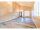 Bright living room showcasing high ceilings, a staircase, and stylish wood-look flooring at 6778 W Lariat Ln, Peoria, AZ 85383