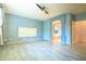 Open primary bedroom featuring blue walls, a fan, wood-look tile flooring, and an archway to the bath at 6778 W Lariat Ln, Peoria, AZ 85383