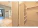 Spacious walk-in closet with built-in shelving and a rod for hanging clothes, conveniently located near the bathroom at 6778 W Lariat Ln, Peoria, AZ 85383