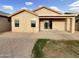 Backyard featuring brick pavers, a covered patio, and lush green grass at 7215 N 123Rd Dr, Glendale, AZ 85307