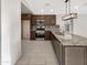 Open kitchen with granite countertops, stainless steel appliances, and tile flooring at 7215 N 123Rd Dr, Glendale, AZ 85307
