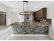 Kitchen island with granite counters, stainless steel appliances, and tile flooring at 7215 N 123Rd Dr, Glendale, AZ 85307