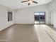 Bright living room featuring wood look flooring and sliding door to the backyard at 7215 N 123Rd Dr, Glendale, AZ 85307