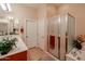 Well-lit bathroom with glass shower, double doors, and neutral tile flooring at 7216 E Aurora --, Scottsdale, AZ 85266