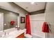 Bathroom with a shower-tub combo, large mirror, and red accents at 7216 E Aurora --, Scottsdale, AZ 85266