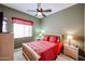Cozy bedroom with ceiling fan, window, red bedding and bedside tables at 7216 E Aurora --, Scottsdale, AZ 85266