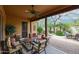 Inviting covered patio with comfortable seating, a ceiling fan, and views of the lush landscaping at 7216 E Aurora --, Scottsdale, AZ 85266