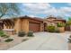 Charming exterior showcasing a well-maintained lawn, a private garage, and a stone archway entry at 7216 E Aurora --, Scottsdale, AZ 85266