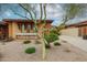 Inviting front yard featuring desert landscaping and a charming porch with stone accents on a sunny day at 7216 E Aurora --, Scottsdale, AZ 85266