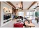 Comfortable living room featuring a stone fireplace, exposed beams, and modern furnishings at 7216 E Aurora --, Scottsdale, AZ 85266