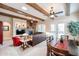 Spacious living room showcasing exposed beams, a stone fireplace, and comfortable seating at 7216 E Aurora --, Scottsdale, AZ 85266
