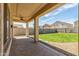 A covered back patio offers an outdoor space looking out to a grassy, fenced-in backyard at 7622 S 69Th Dr, Laveen, AZ 85339