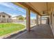 Enjoy a covered back patio overlooking a fenced pool, grassy area and gravel at 7622 S 69Th Dr, Laveen, AZ 85339