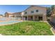 View of the backyard with lawn and fenced pool, under blue skies at 7622 S 69Th Dr, Laveen, AZ 85339