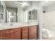 Bathroom featuring a shower-tub combo, double vanity, and large mirror at 7622 S 69Th Dr, Laveen, AZ 85339