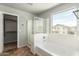 Bathroom with a walk-in shower and a soaking tub by a window at 7622 S 69Th Dr, Laveen, AZ 85339