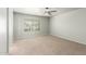 Spacious bedroom with neutral carpet, ceiling fan, and a bright window at 7622 S 69Th Dr, Laveen, AZ 85339
