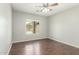 Bedroom featuring hardwood floors, a ceiling fan, and a view of the backyard pool at 7622 S 69Th Dr, Laveen, AZ 85339